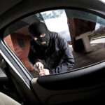 robber and the thief in a mask hijacks the car